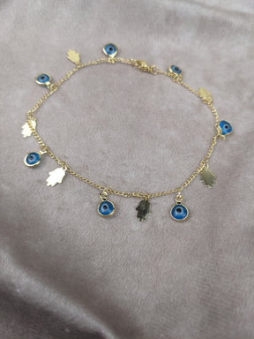 Goldenes Gliederarmband zart mit blauen emailleaugen und goldener hand